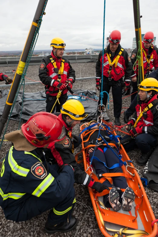 men standing around a rescue device on the ground