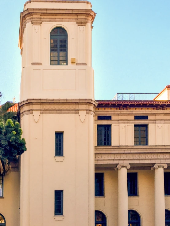 a tall building with a clock on top and some stairs leading up