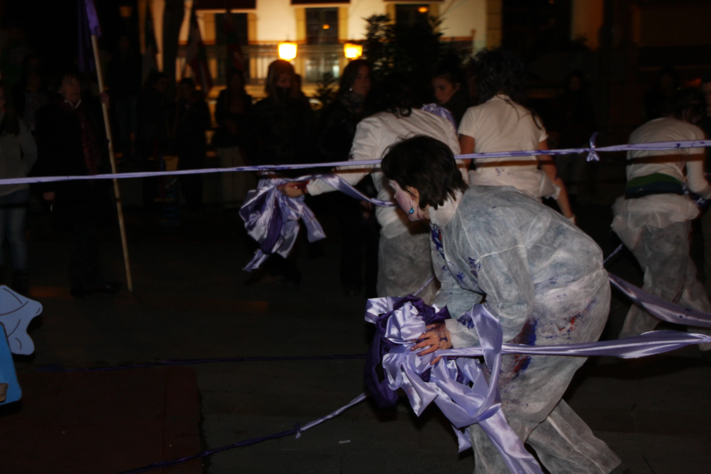 man in a full body costume putting on a ribbon