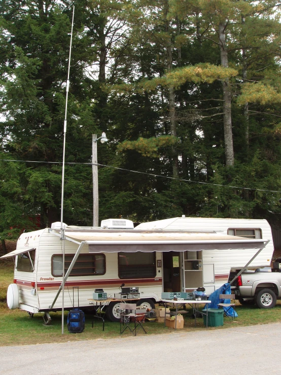 a rv parked in the driveway with a camper beside it