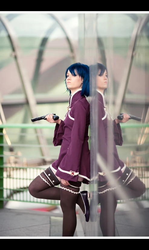 two girls with dark blue hair and black boots dressed in schoolgirl outfits