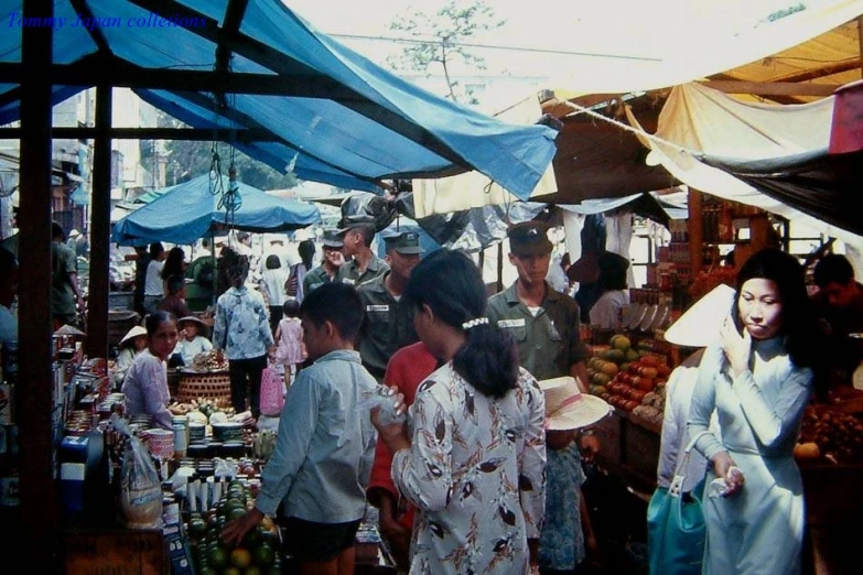 a crowded marketplace with people walking around