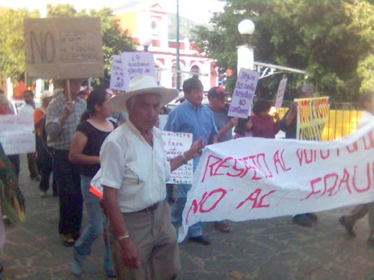 the group of men and women are carrying protest signs