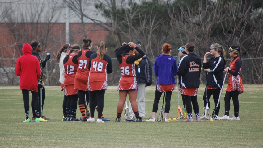 a group of women standing around a soccer ball