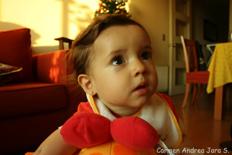 there is a young child wearing a red and yellow bib