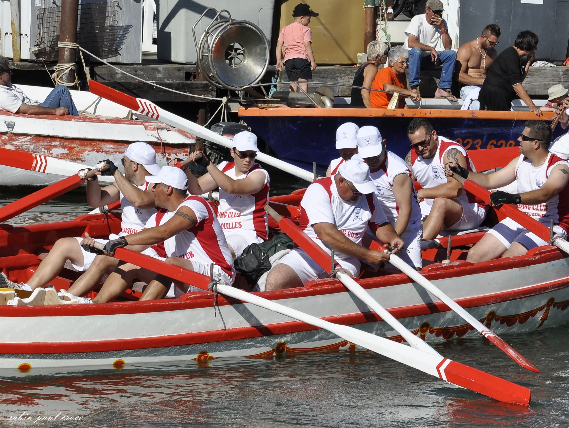 several people in a rowing boat on the water