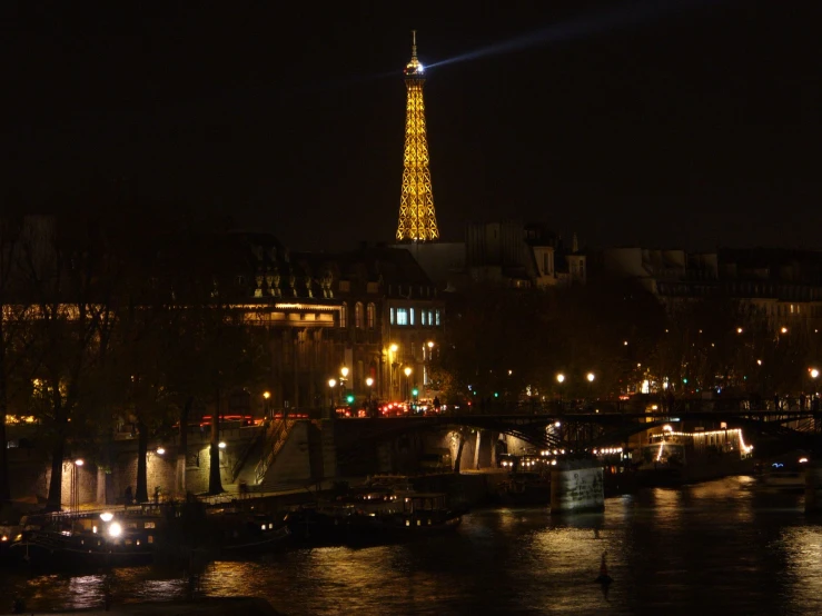 the eiffel tower is lit up at night