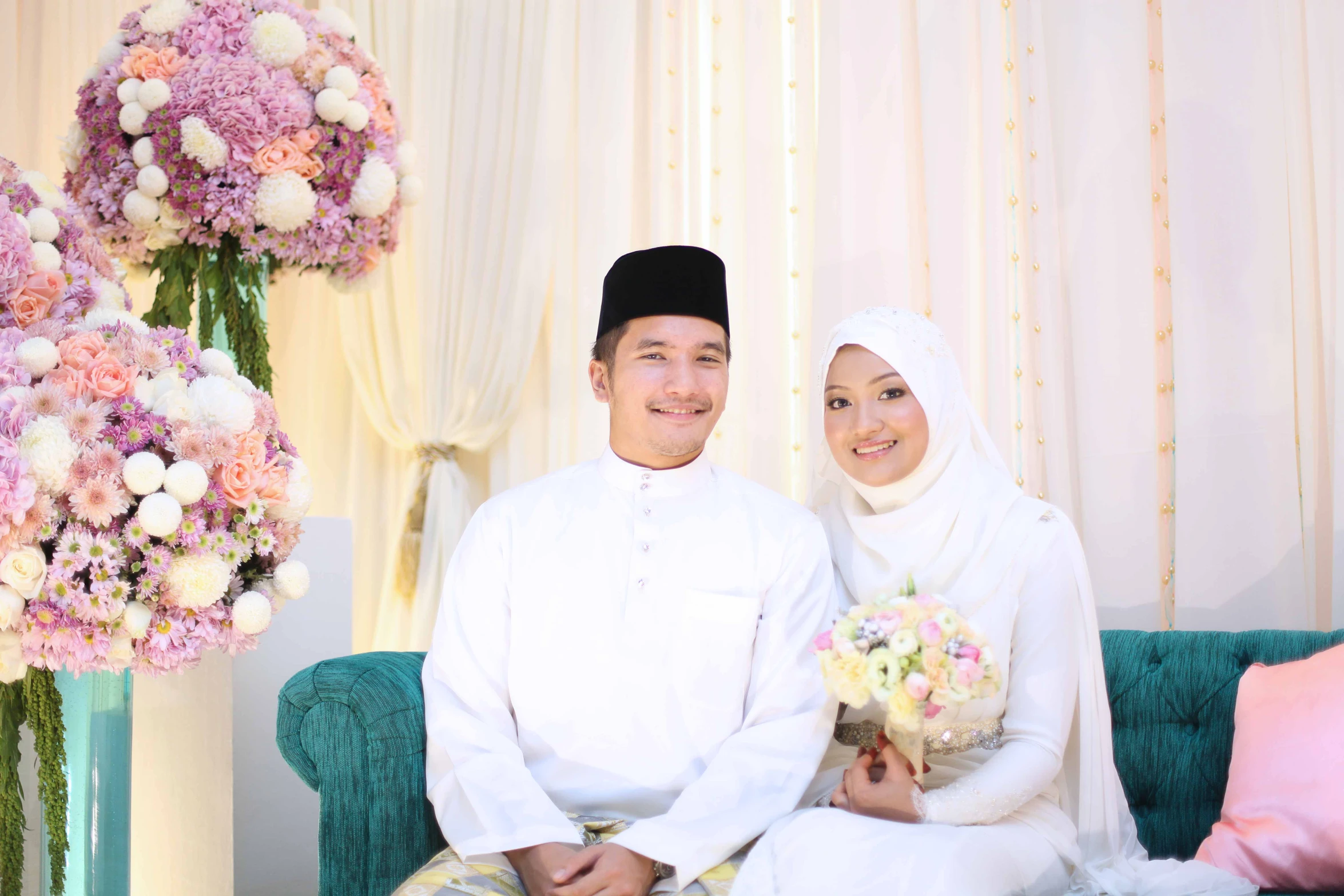 two people are dressed in traditional clothing sitting next to each other