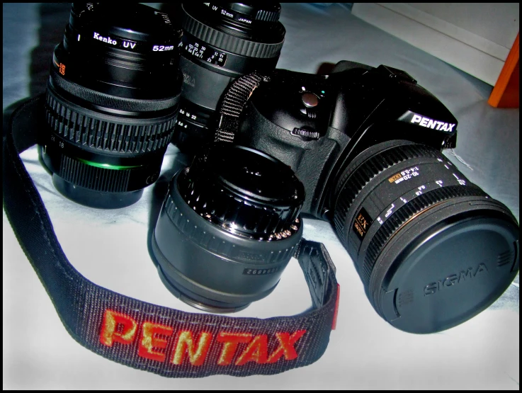 three camera bodies displayed on display with lens strap