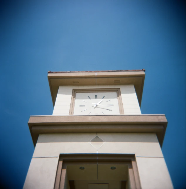a white clock on top of a white brick tower