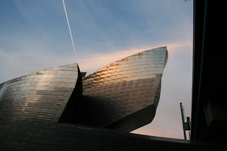 an air plane in the sky above a building