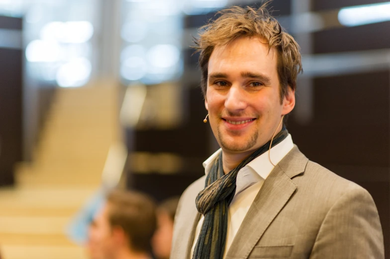 a close up of a person wearing a suit and tie