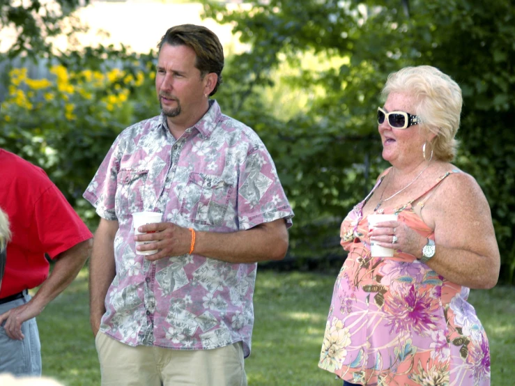 a man and woman with drinks in their hands