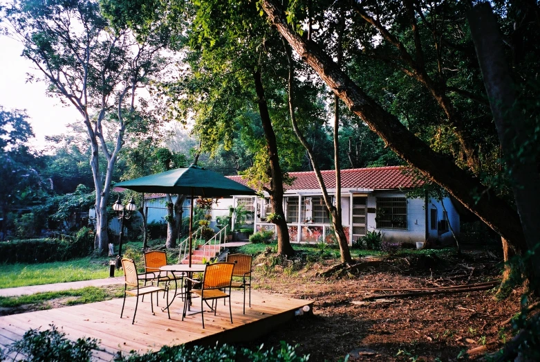 there is a table and chairs on the wood platform