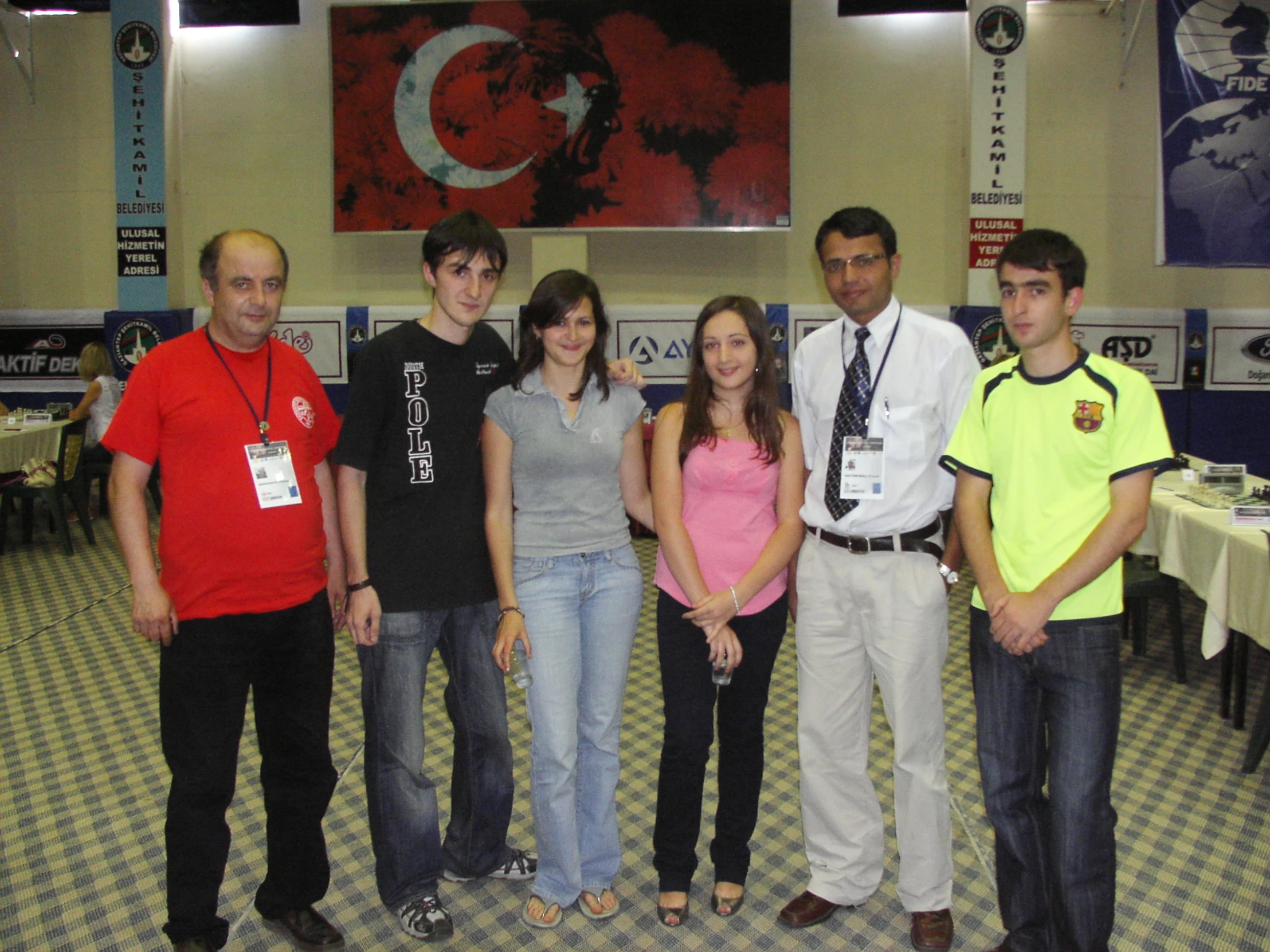 a group of people standing next to each other on checkered floor