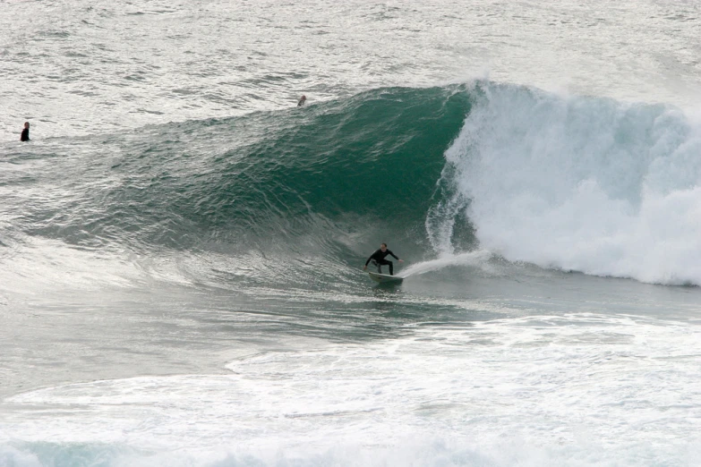 a person riding a wave on top of a surfboard