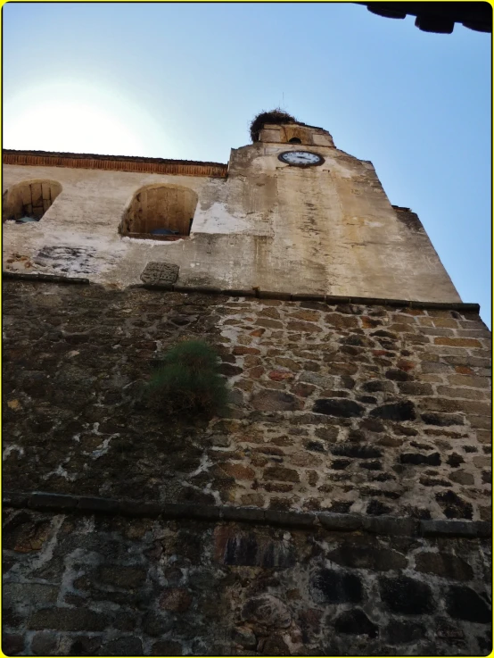 a building with a clock that has two windows and is made of brick