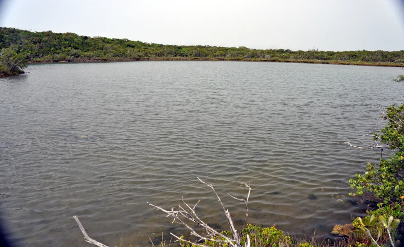 a large body of water sitting on the side of a hill