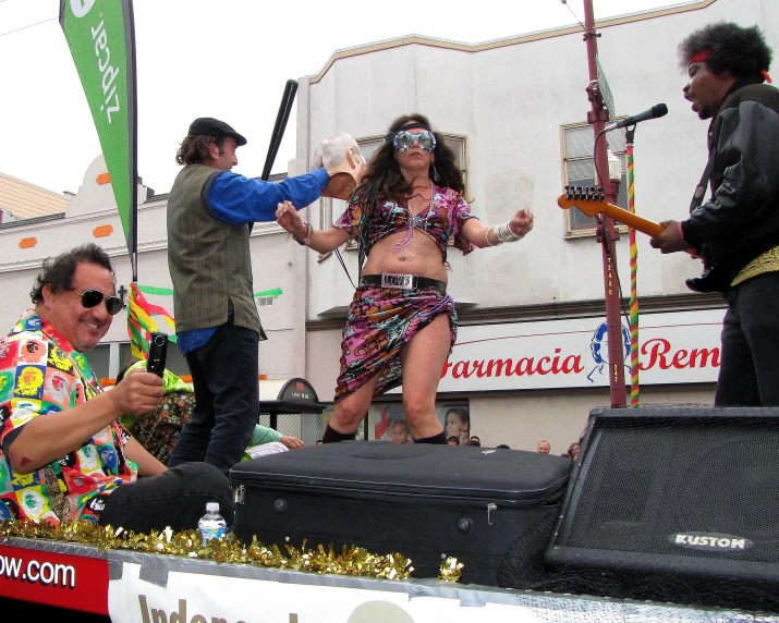 some people in costumes on stage with guitar and an instrument