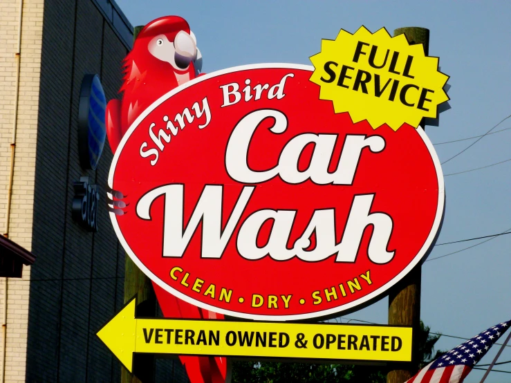 a sign with a red bird perched on the top of it