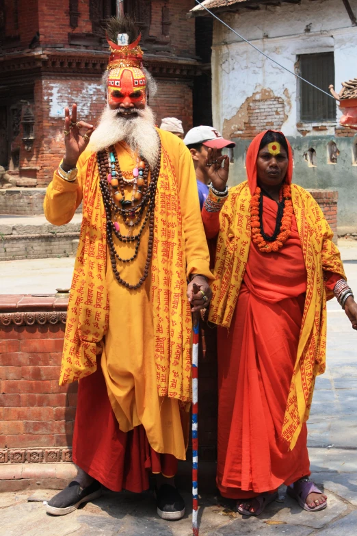 men in indian costume stand together outside