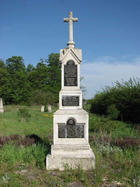 a cemetery with a large cross and tombstones