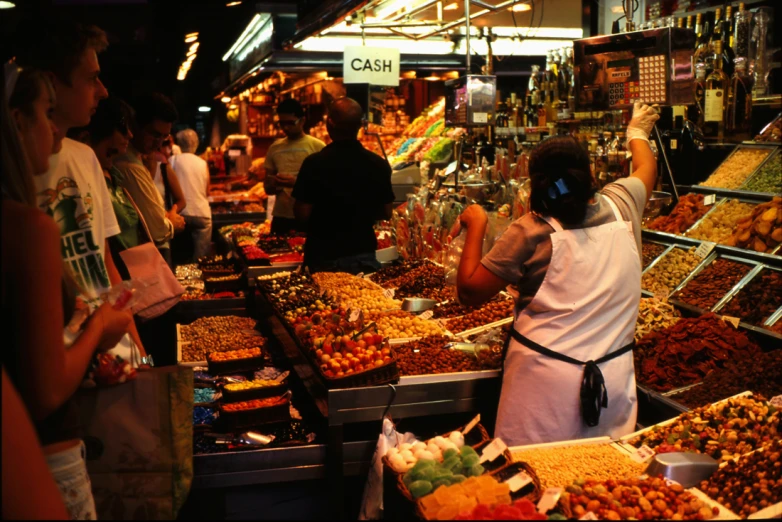 people shopping at an open air market with fresh produce