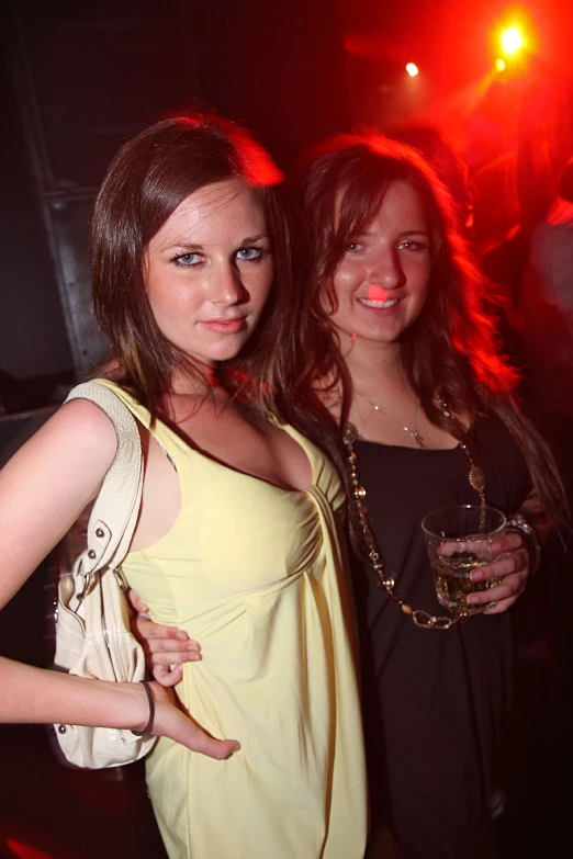 two ladies in a club pose for the camera