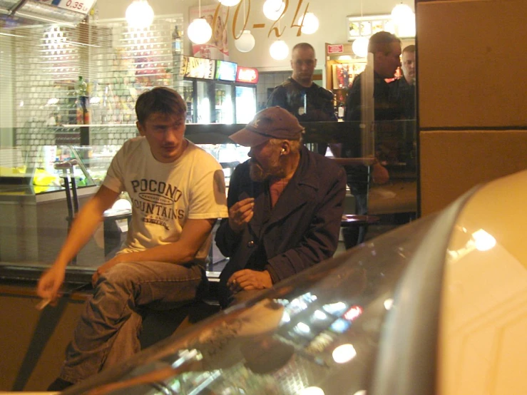 two men are sitting at a diner table