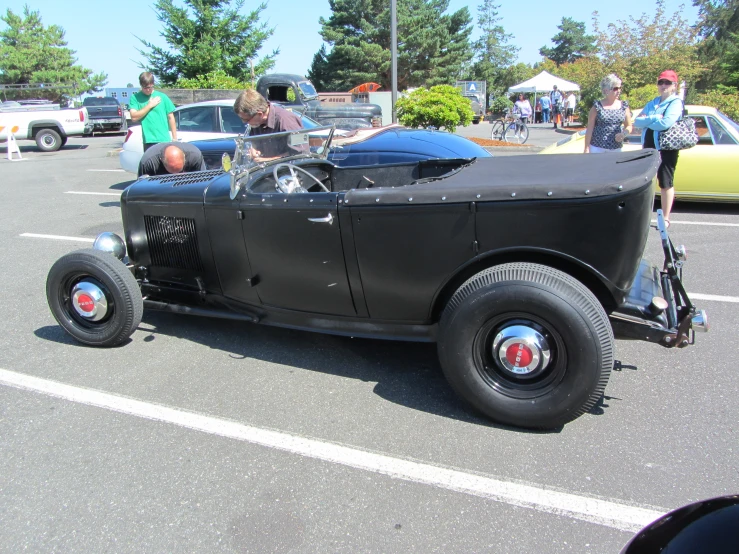 vintage cars are parked in a parking lot