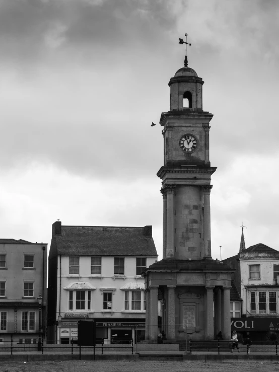 a tower with a clock that is standing on it