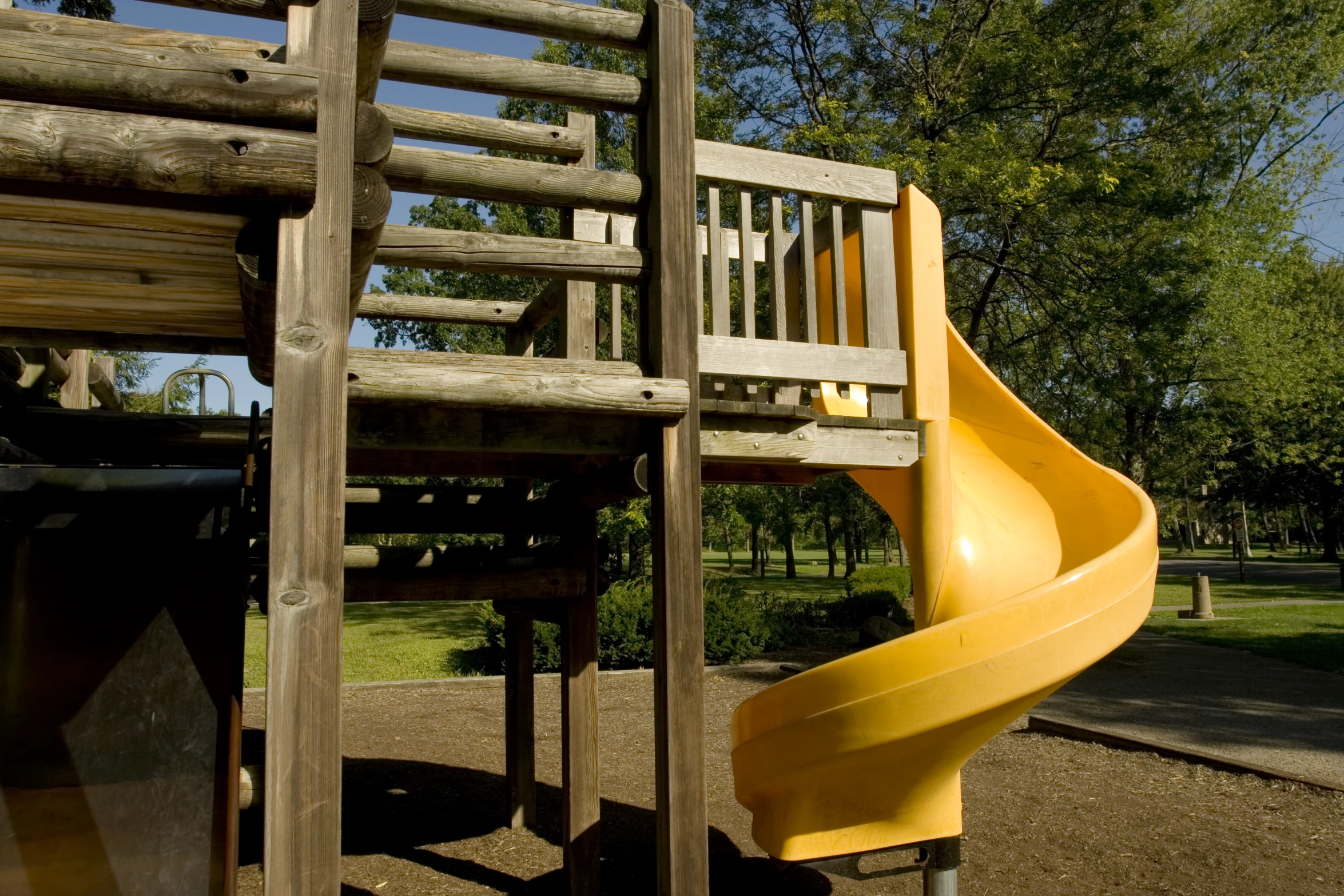 an unfinished playground structure with slide in the background