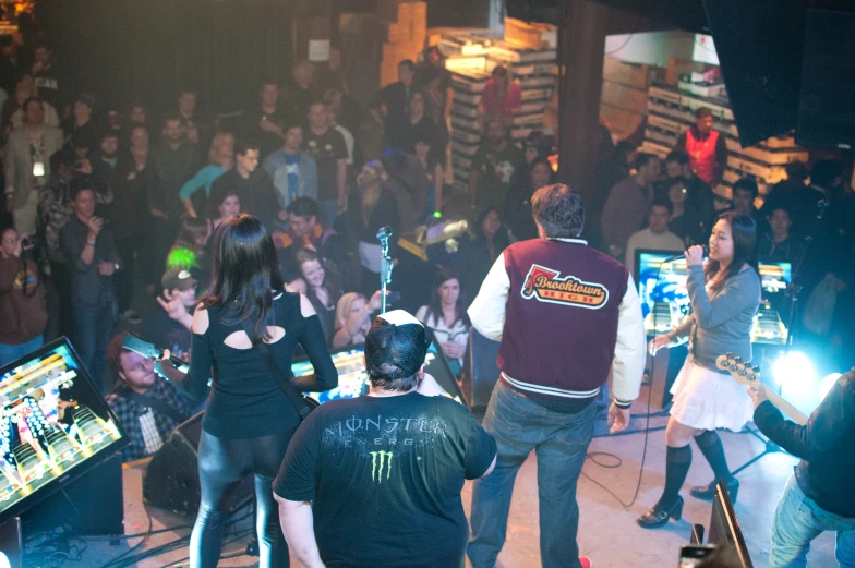 a large group of people standing around in a room