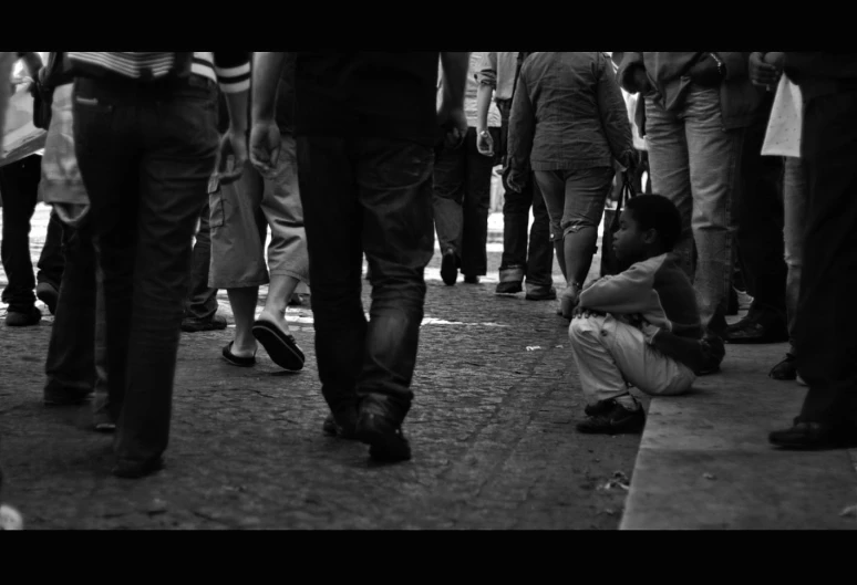 a child is sitting in the middle of a group of people