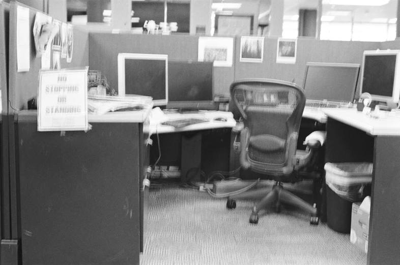 black and white po of desk with office chairs