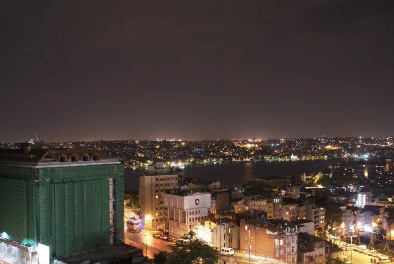 the view from a tall building at night of city lights