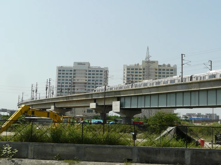 a train is driving over an elevated bridge