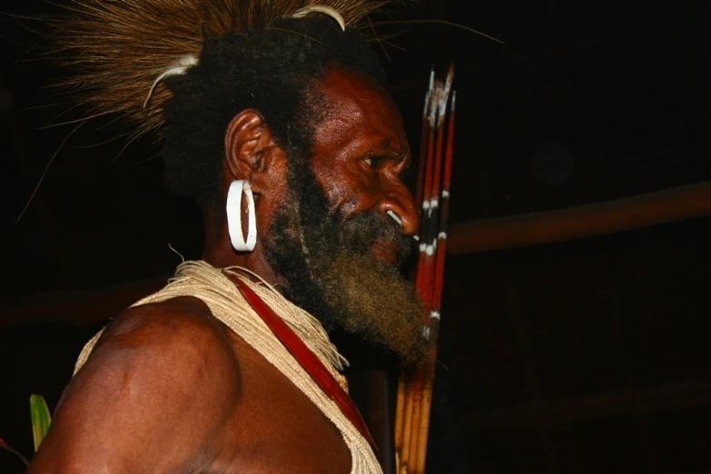 an indigenous man with his hair blowing back