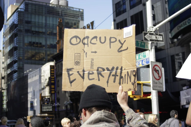 a protest sign with writing on the back of it