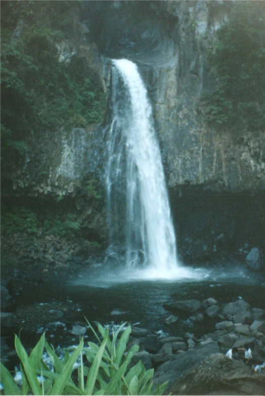 the water fall is running down the side of the cliff