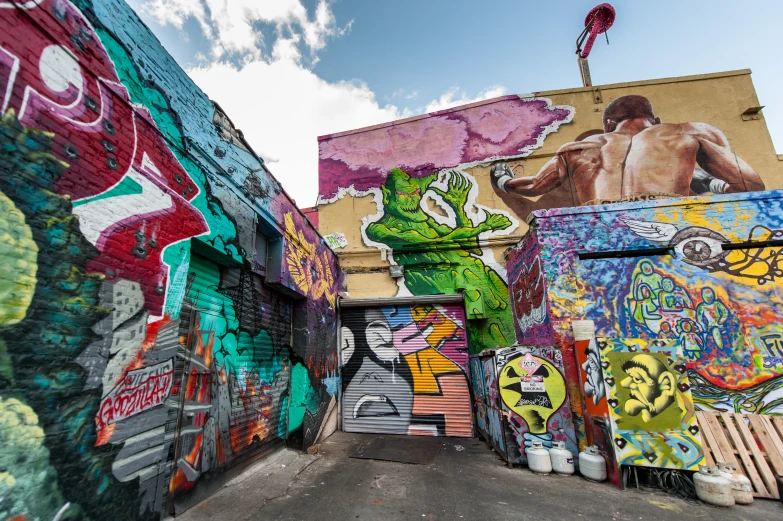 several graffiti covered walls with a boy standing on a skateboard