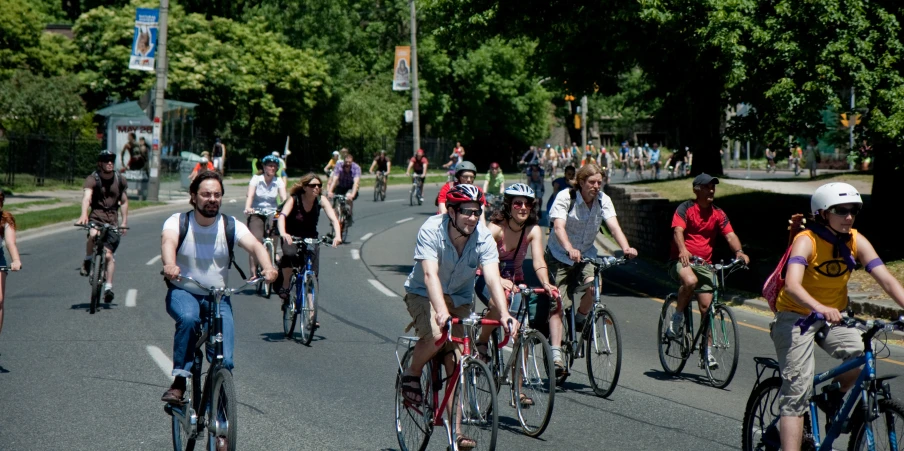 the people are riding their bikes in the street