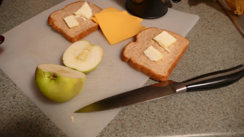 bread and cheese slices with apples, with a knife