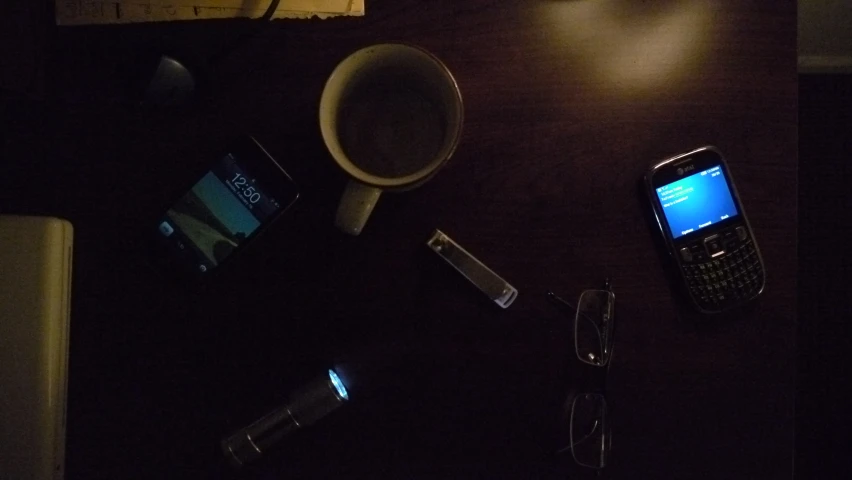 various objects on table lit up by a smart phone