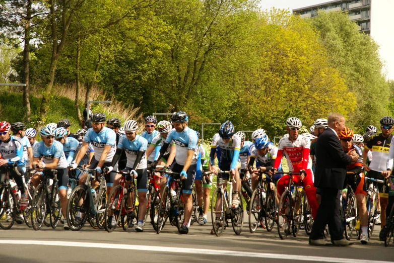 a large group of people on bikes, some in uniform