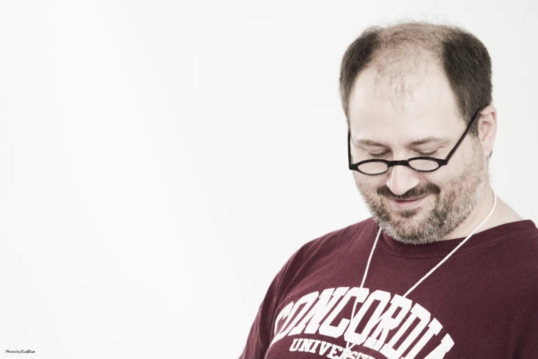 man in glasses listening to music with headphones on