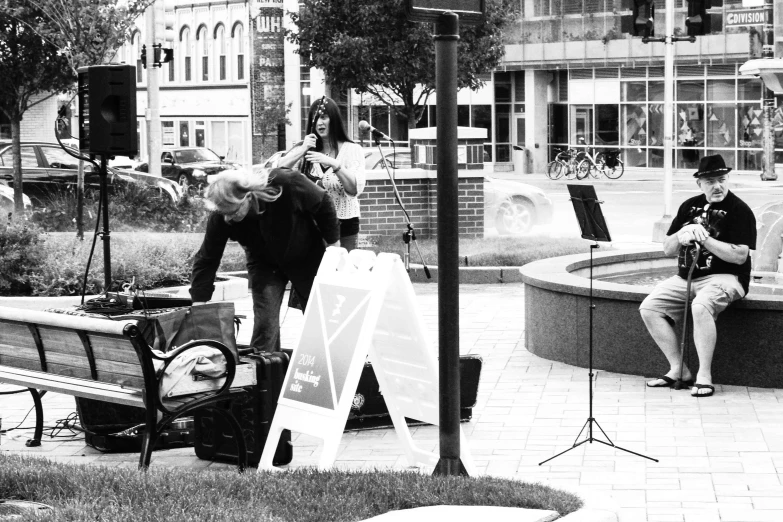 a woman is singing in front of a piano