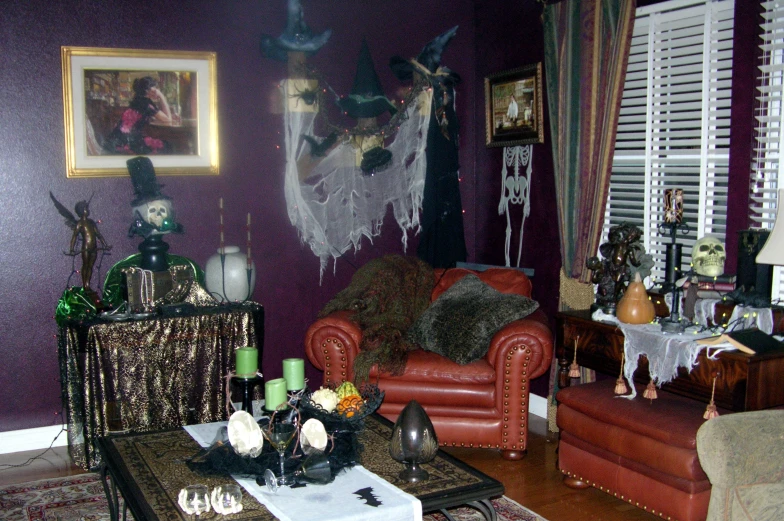 a halloween scene of a living room filled with fake doll and decor