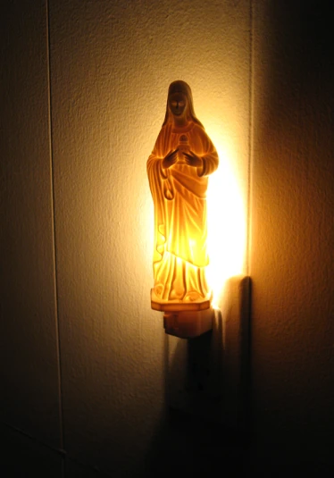 light fixture in the shape of statue and bulb