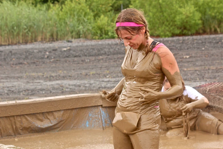 the woman is covered in mud with an arm warmer